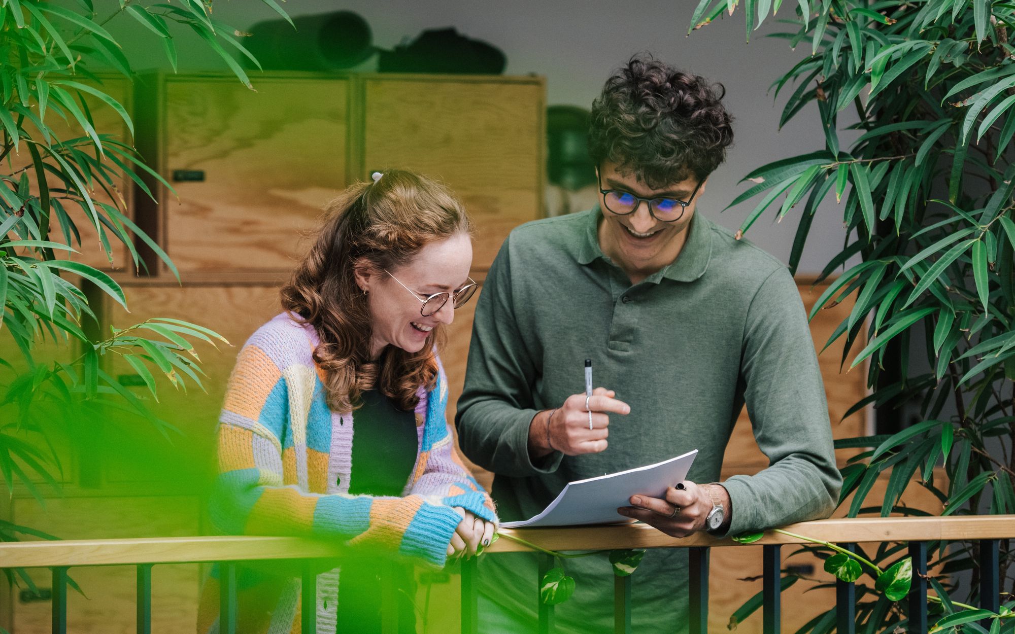 co-workers talking in an open office space