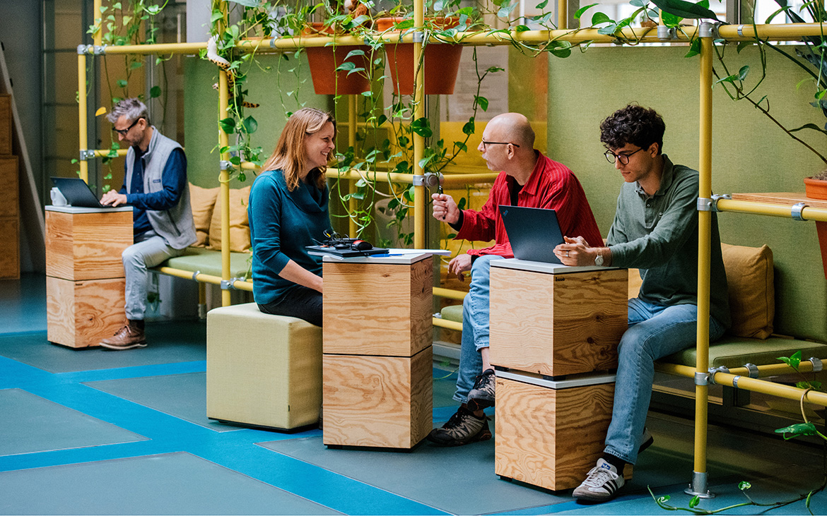 co-workers talking in an open office space