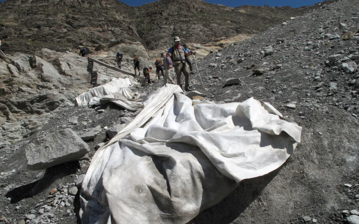 Wanderer auf dem Gornergletscher mit Tarpulin Tüchern gegen Gletscherschmelze