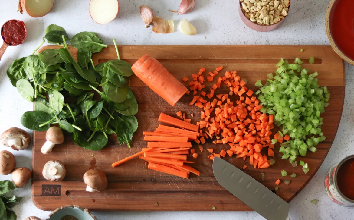 Ingredients for a vegan Bolognese on a wooden board