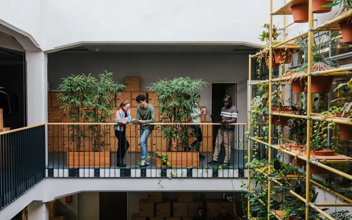 co-workers talking in an open office space