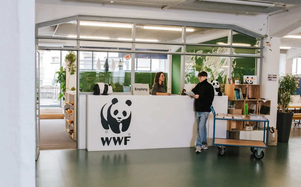 co-workers talking in an open office space