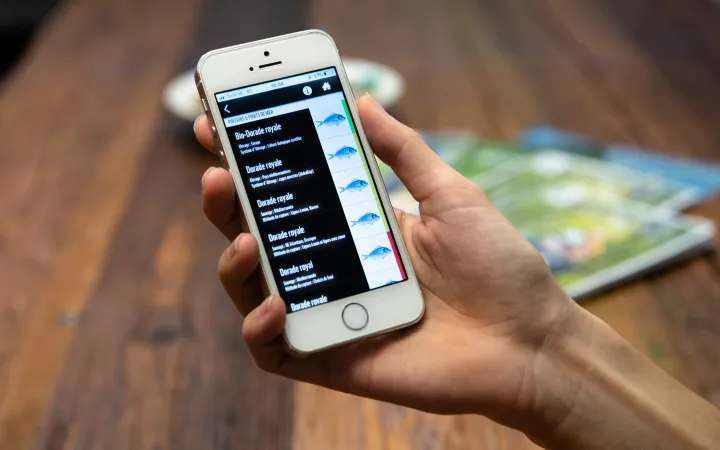 Personne tenant smartphone avec application open guide WWF