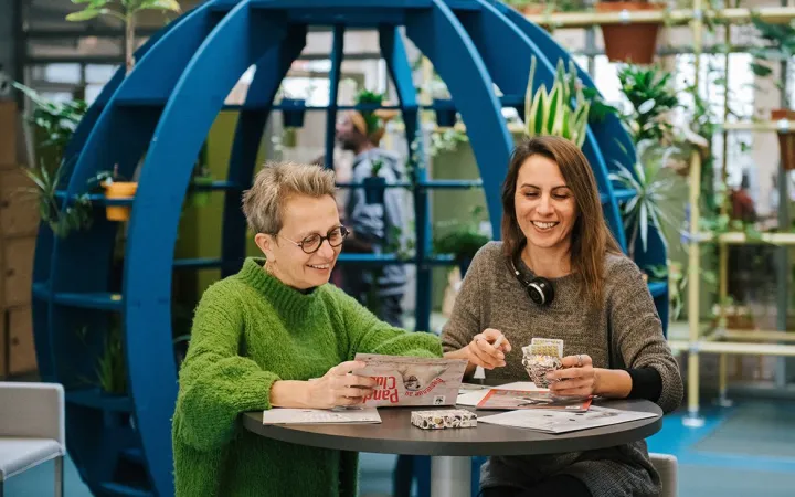 co-workers talking in an open office space