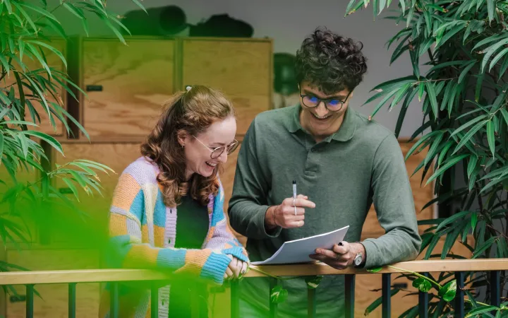 co-workers talking in an open office space