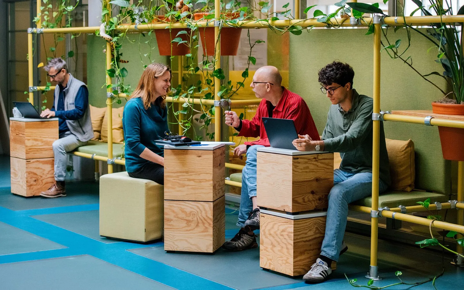 co-workers talking in an open office space