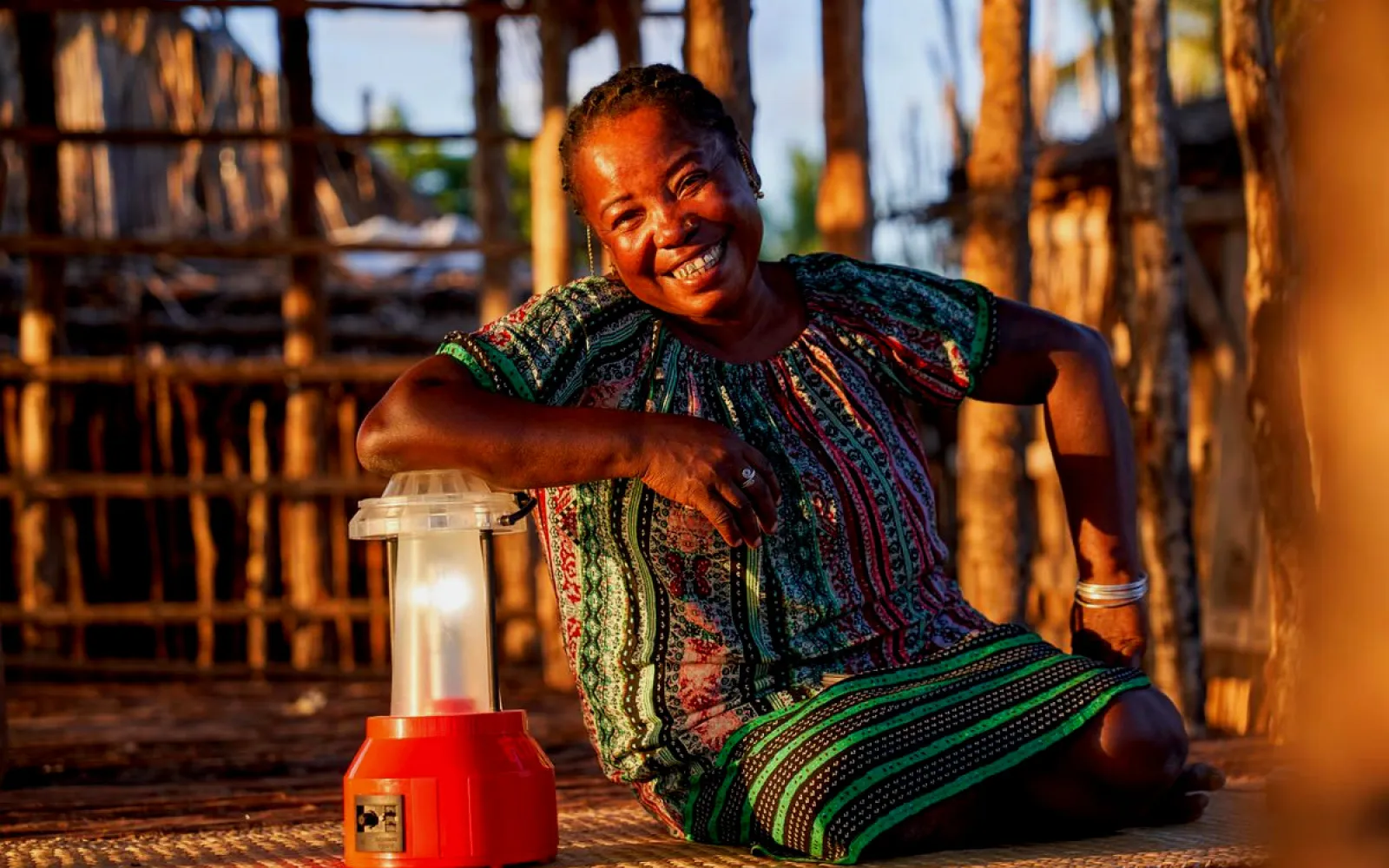 solar technician Kingaline sits next to a solar lamp, Barefoot College Madagascar