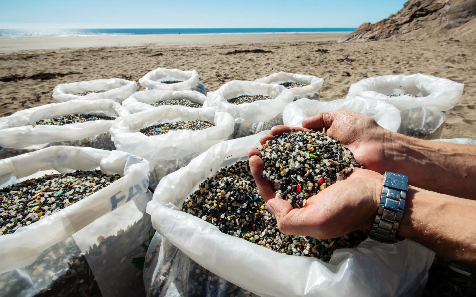 bags full with microplastics on the beach