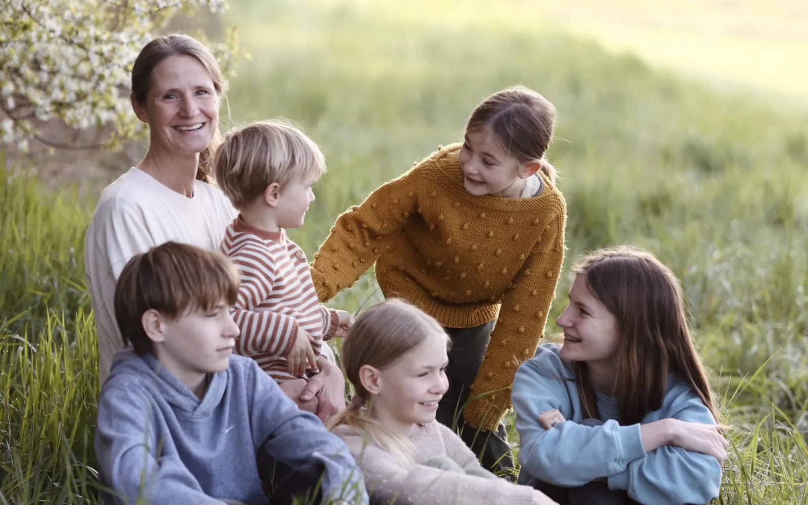family sitting in field