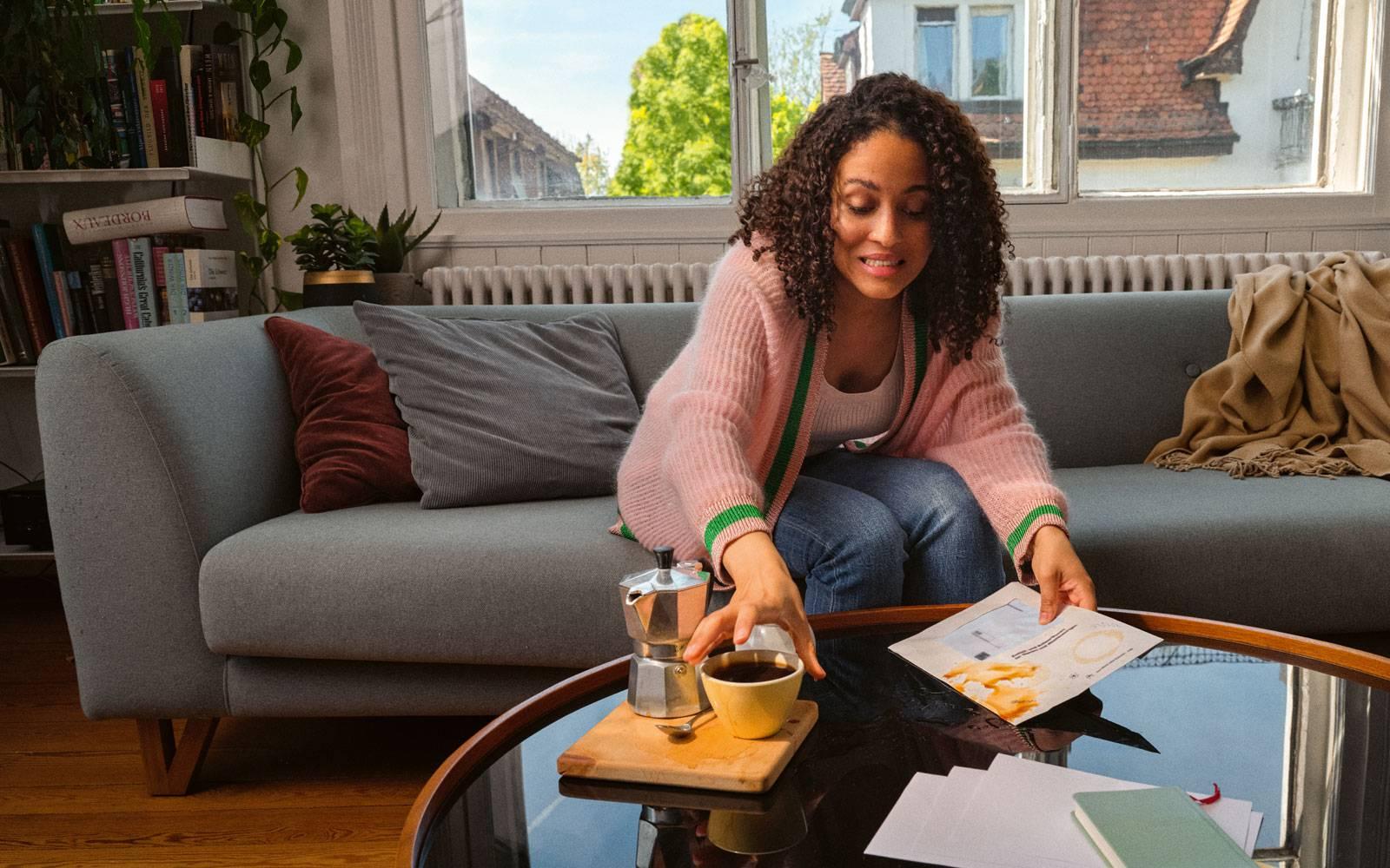 Woman spilling coffee over voting materials