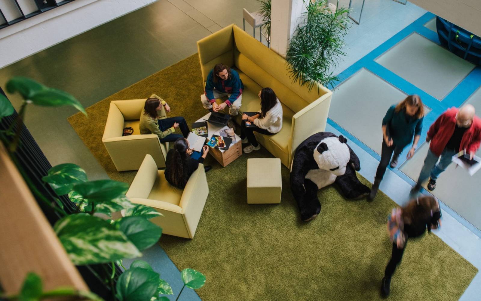 co-workers talking in an open office space