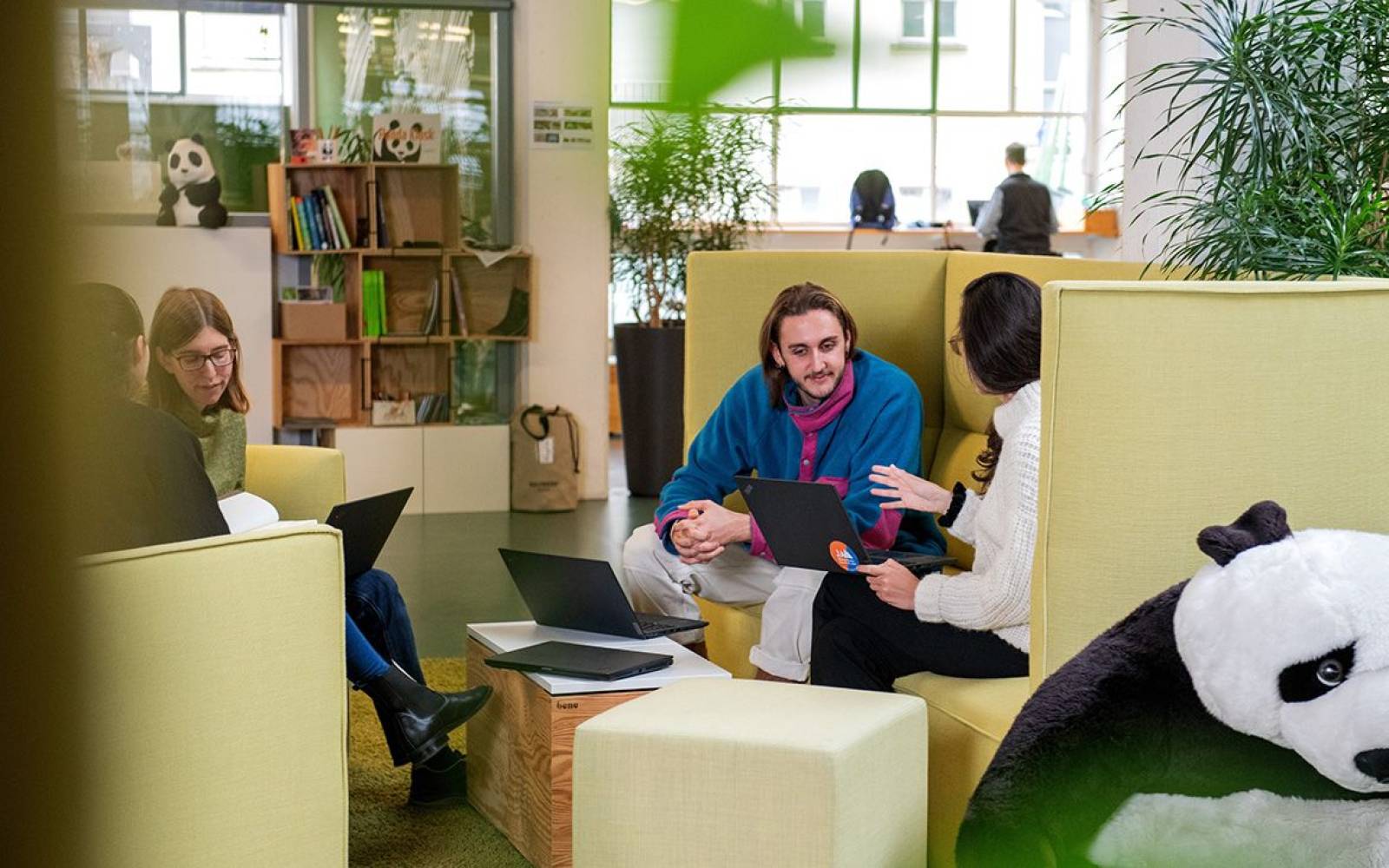 co-workers talking in an open office space