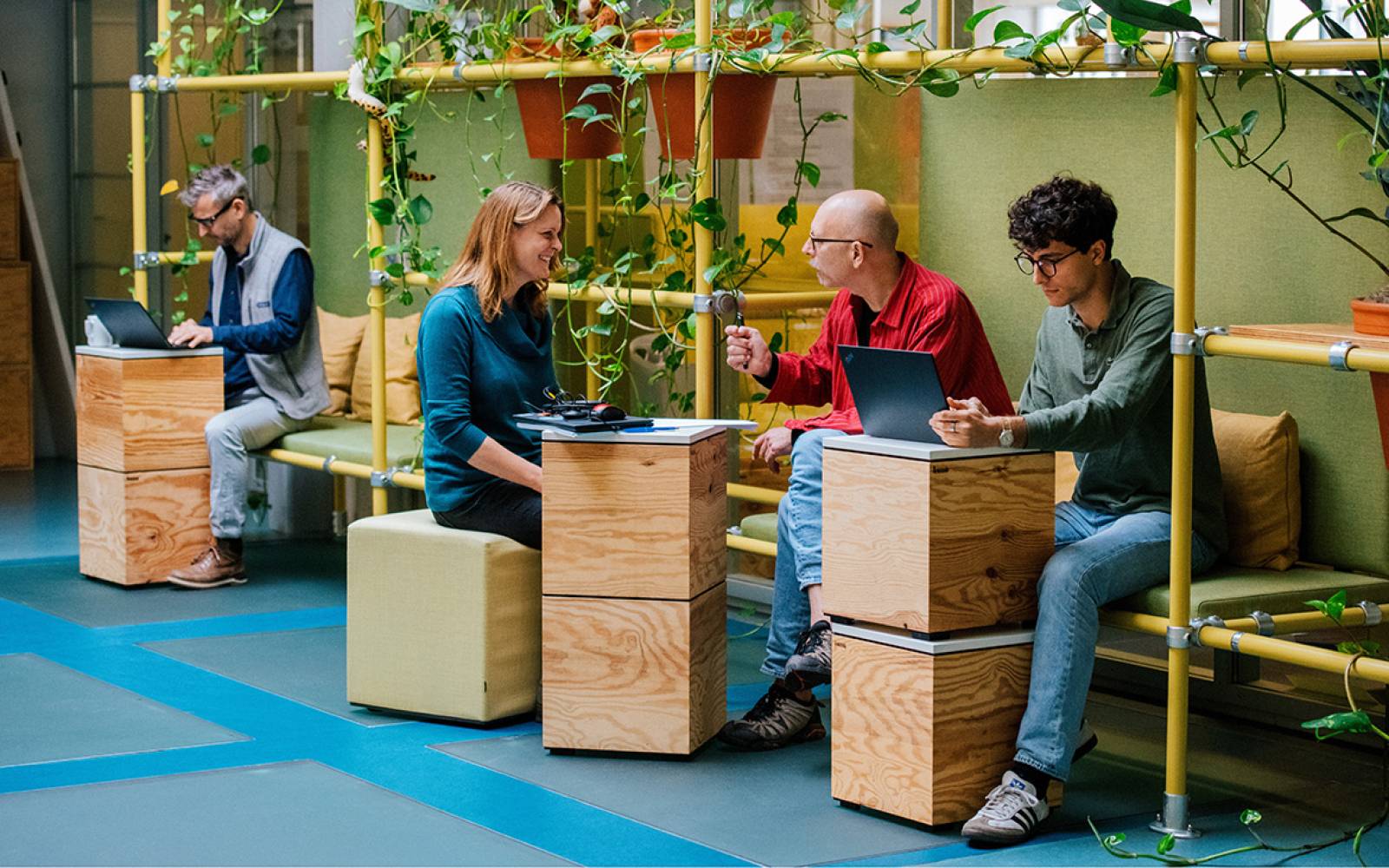 co-workers talking in an open office space