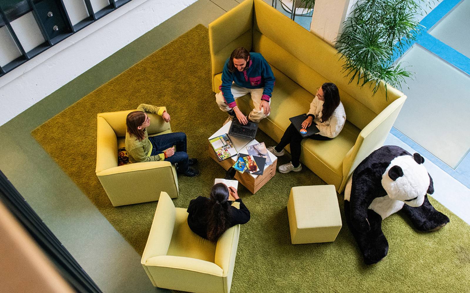 co-workers talking in an open office space