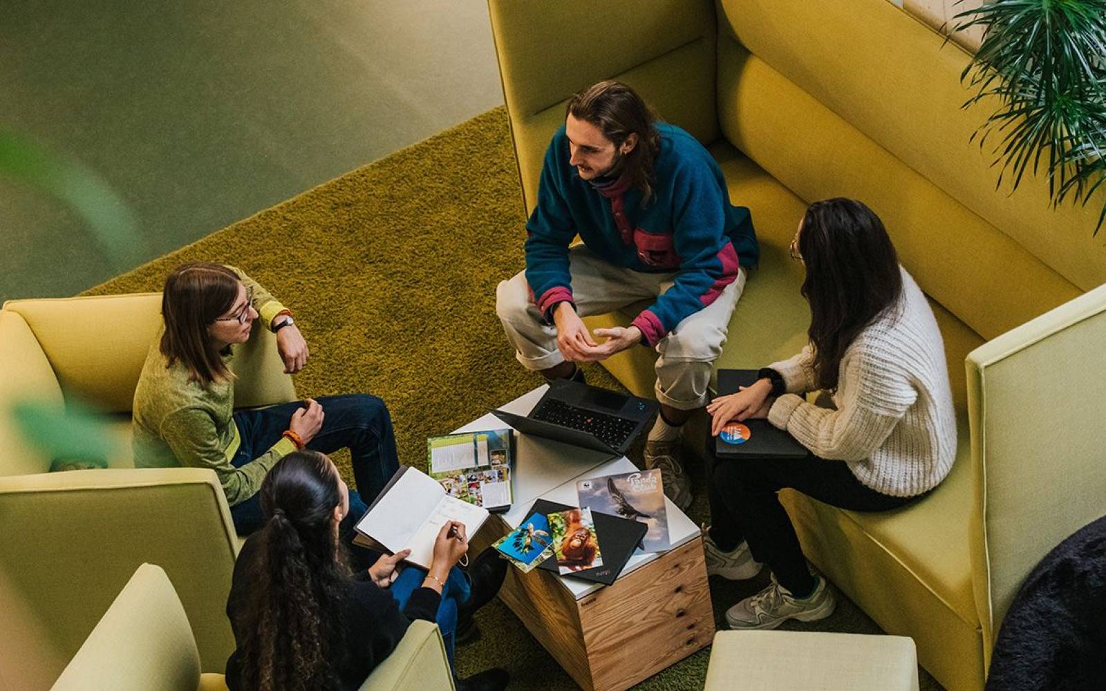 co-workers talking in an open office space