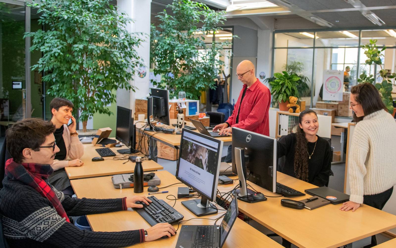 co-workers working in an open office space