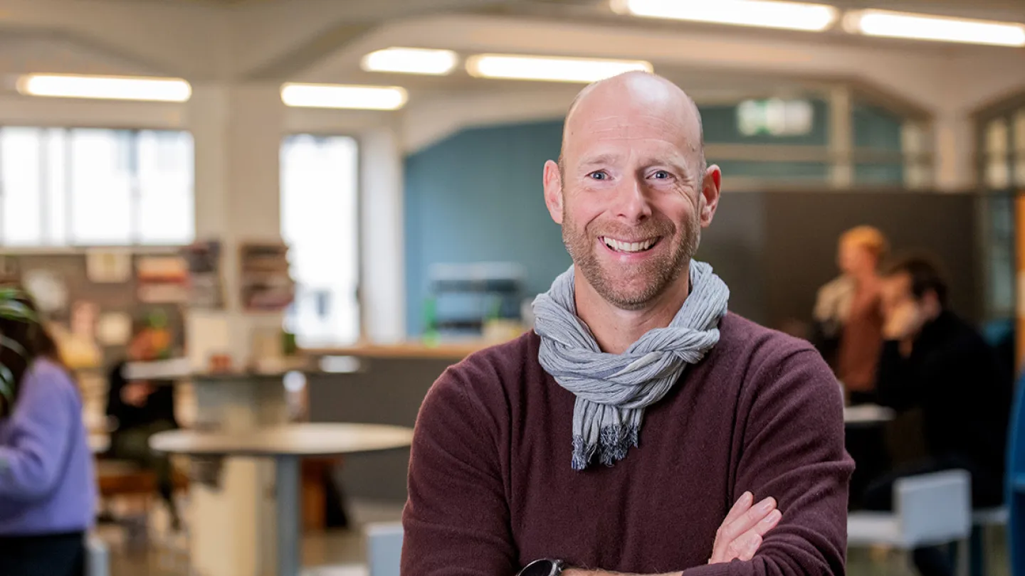 man standing in the office smiling at camera