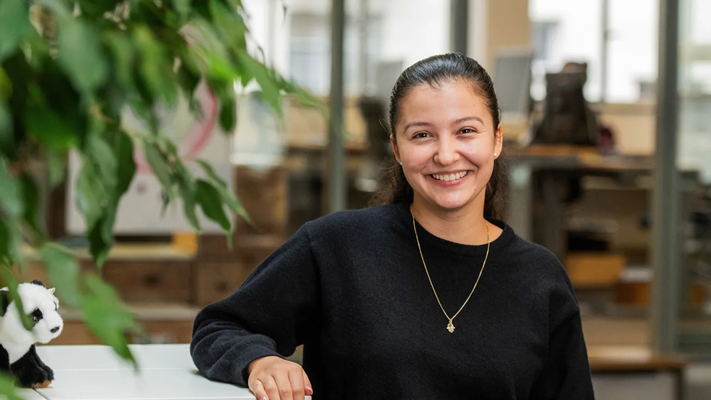 woman standing in office smiling at camera