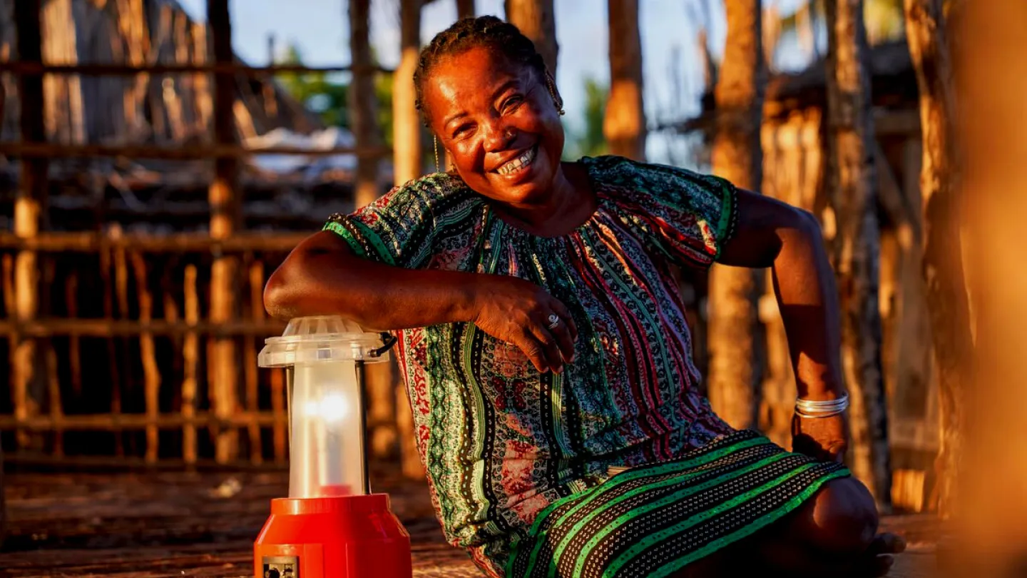 solar technician Kingaline sits next to a solar lamp, Barefoot College Madagascar