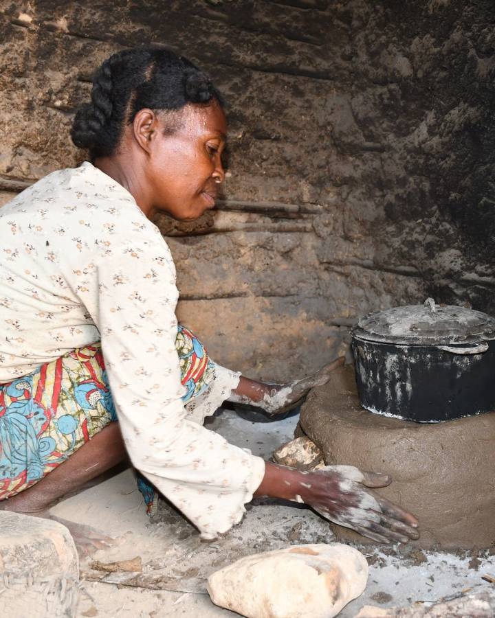 Women in Madagascar building energy efficient stove